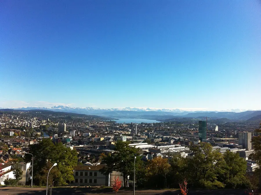 Panorama einer Stadt am See mit Bergen am Horizont
