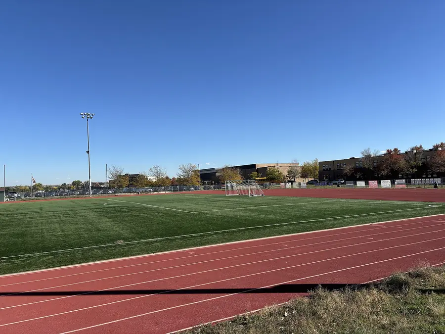Leichtathletikstadion bei Tageslicht mit Rundbahn und Innenraum